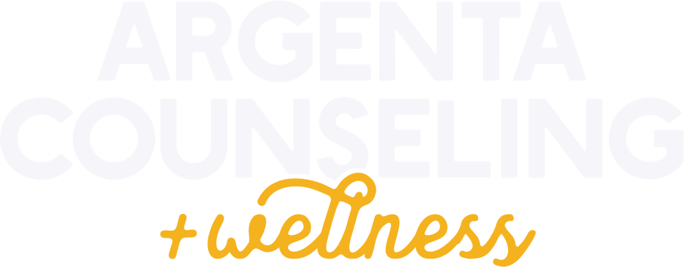 A text-based logo featuring the words "ARGENTA COUNSELING" faintly written in a very light, desaturated violet or off-white sans-serif font stacked across two lines. Below it, "+ wellness" stands out in a vibrant gold, cursive script font against a transparent background.