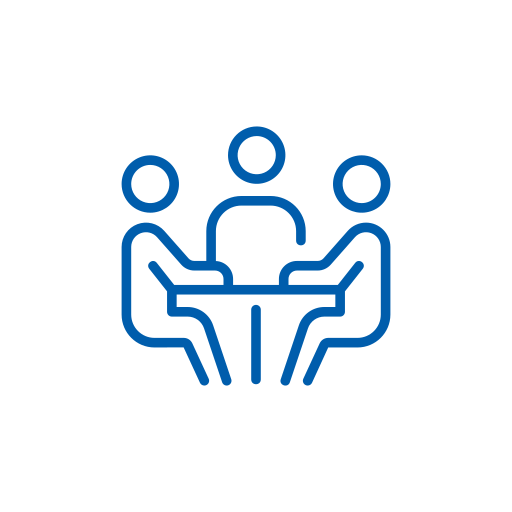 A blue line-art icon depicting three minimalist figures seated around a conference table, suggesting a meeting, panel discussion, or group therapy session. The design is isolated on a transparent background.